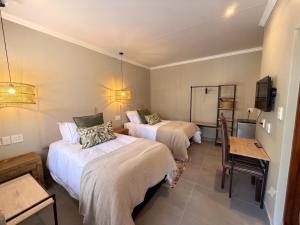 a room with two beds and a chalkboard in it at Die Boord Guesthouse in Crocodile Valley Estates