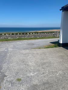 an empty parking lot with the ocean in the background at The Tackroom in Fanore +1 photo