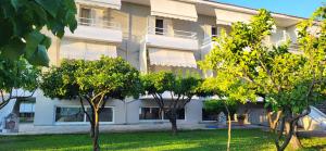 a building with trees in front of it at K SANTIS STUDIOS in Pefki
