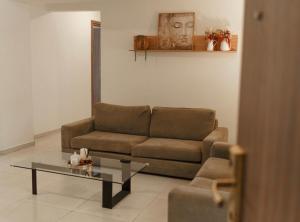 a living room with a couch and a coffee table at Halcyon Central Apartments in Larnaca