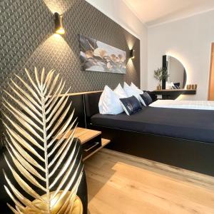 a hotel room with a bed and a palm plant at Wellness-Oase-Nossen Kirchblick in Nossen