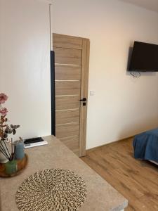 a room with a door and a table with a rug at WINE NOT Tállya in Tállya