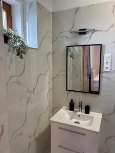a white bathroom with a sink and a mirror at WINE NOT Tállya in Tállya +31 photos