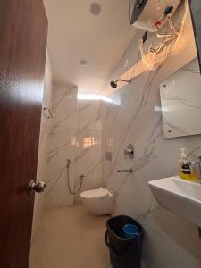 a bathroom with a toilet and a sink at hotel wisdom celebration in Motīhāri