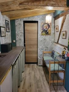 a room with a door and a couch and a table at Le nid de la mare in Mervans