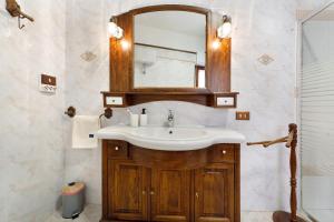 a bathroom with a sink and a mirror at Casa Lele in Sarroch +17 photos