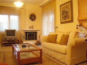 a living room with a couch and a coffee table at Litochoro Apartments in Litochoro