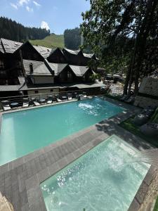 a large swimming pool in front of a house at ТерКон-Тур in Bukovel