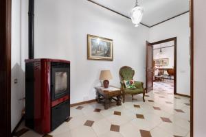 a living room with a tv and a chair at Casa Lele in Sarroch