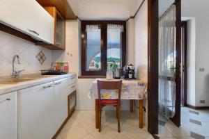 a kitchen with a small table and a window at Casa Lele in Sarroch