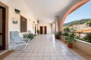 a room with a chair on a balcony at Casa Lele in Sarroch