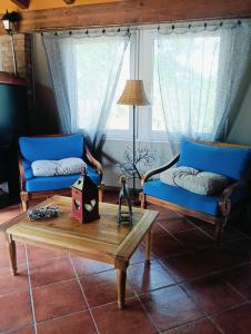 a living room with two blue couches and a coffee table at Cascina Rocchino bed and breakfast in Predosa +35 photos
