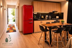 a kitchen with a red refrigerator and a table at Pinecone Luxury Glamping in Louvaras