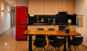 a kitchen with a wooden table and a red refrigerator at Pinecone Luxury Glamping in Louvaras +15 photos