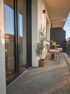 a balcony with a bench and a table on a building at Apartament 1go Maja TK in Namysłów