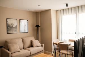 a living room with a couch and a table at TeneaHome - Escuelas Pías in Yecla +14 photos