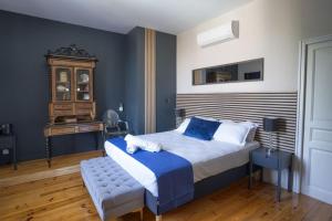 a bedroom with a large bed with blue and white at Maison Bacchus 31 in Buzet-sur-Tarn +100 photos
