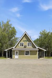 a large yellow house with a garage at Birch Glen Hotel in Cascade
