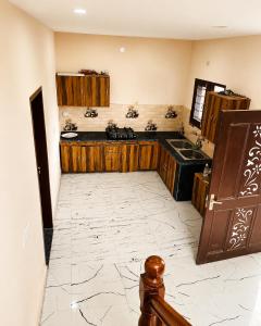 a kitchen with wooden cabinets and a sink at The Nawab's Villa in Mānakpur