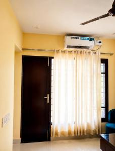 a room with a door and a window with a heater at The Nawab's Villa in Mānakpur +6 photos