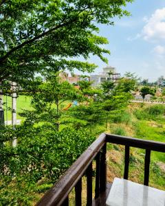 a view of a park from a balcony at The Nawab's Villa in Mānakpur