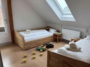 a bedroom with two beds and toys on the floor at Dahmerhof in Dahme