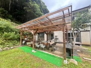 a large wooden pergola with a table and a table at Cruise garden in Kanō +36 photos