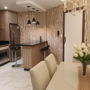 a kitchen with a table and chairs and a counter at Casa familiar in Piên