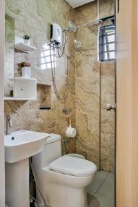 a bathroom with a toilet and a sink and a shower at Casa Gomes Amuntay in Dasmariñas +38 photos