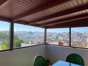 a balcony with a view of a city at TANJALUCIA HOSTeL in Tangier +35 photos