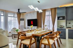 a dining room with a large wooden table with chairs at Casa Gomes Amuntay in Dasmariñas