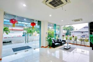 a large living room with a large glass wall at Blue Orchids Hotel in Hat Yai