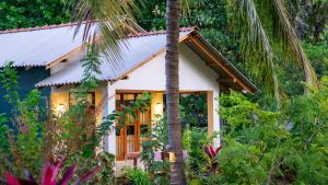 a house in the jungle with a palm tree at Sigiriya Dreamscape Villa in Sigiriya