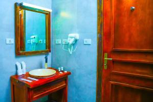 a bathroom with a sink and a mirror at Noora Resort Bishoftu in Debre Zeyit