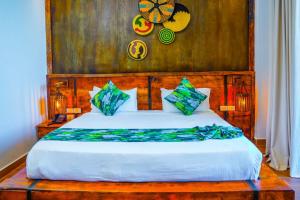 a bedroom with a large bed with a wooden headboard at Noora Resort Bishoftu in Debre Zeyit