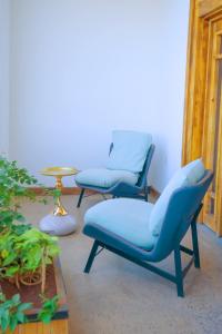 two blue chairs in a room with a table at Noora Resort Bishoftu in Debre Zeyit