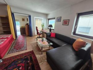 a living room with a couch and a table at Bed & Breakfast Simone in Imst