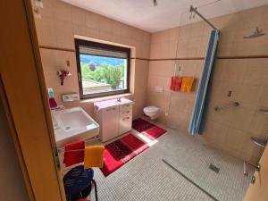 a bathroom with a sink and a shower and a toilet at Bed & Breakfast Simone in Imst +32 photos