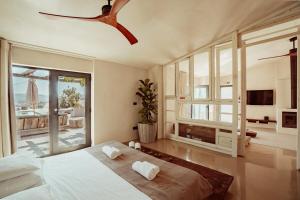a bedroom with a bed and a ceiling fan at Suites Daldeia - Suite 1 in Azueira +43 photos