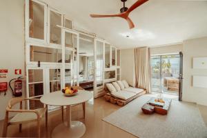 a living room with a table and a couch at Suites Daldeia - Suite 1 in Azueira