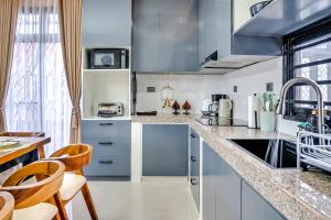 a kitchen with white cabinets and a counter top at Casa Gomes Amuntay in Dasmariñas