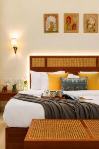 a bedroom with a large bed with yellow pillows at Manovan Resort by Eastlynn Experiences, Jim Corbett in Belparāo