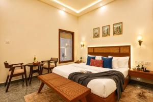 a hotel room with a bed and a table at Manovan Resort by Eastlynn Experiences, Jim Corbett in Belparāo +66 photos