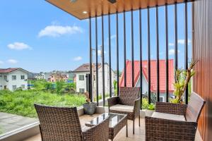 a balcony with chairs and a table with a view at Casa Gomes Amuntay in Dasmariñas