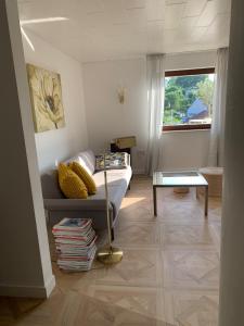 a living room with a couch and a table at Refugium - central, quiet apartment with terrace in Frankenberg
