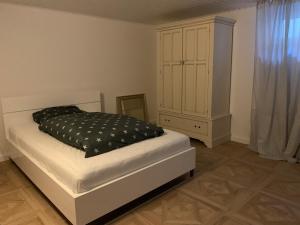 a bedroom with a bed and a dresser at Refugium - central, quiet apartment with terrace in Frankenberg