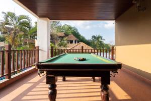 a pool table on the balcony of a house at The Phuket Pool Villa in Phuket
