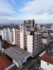 a building with a hotel sign on it in a city at Hz Hotel in Patos de Minas