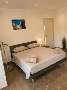 a bedroom with a large bed with towels on it at I Due Moli 2'0 Vibo Marina in Vibo Valentia Marina +20 photos