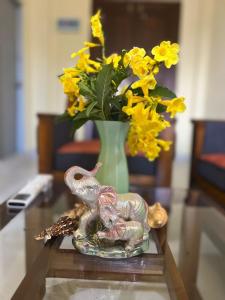 a statue of an elephant on a table with a vase at Donald House Cabana Kandy in Kandy